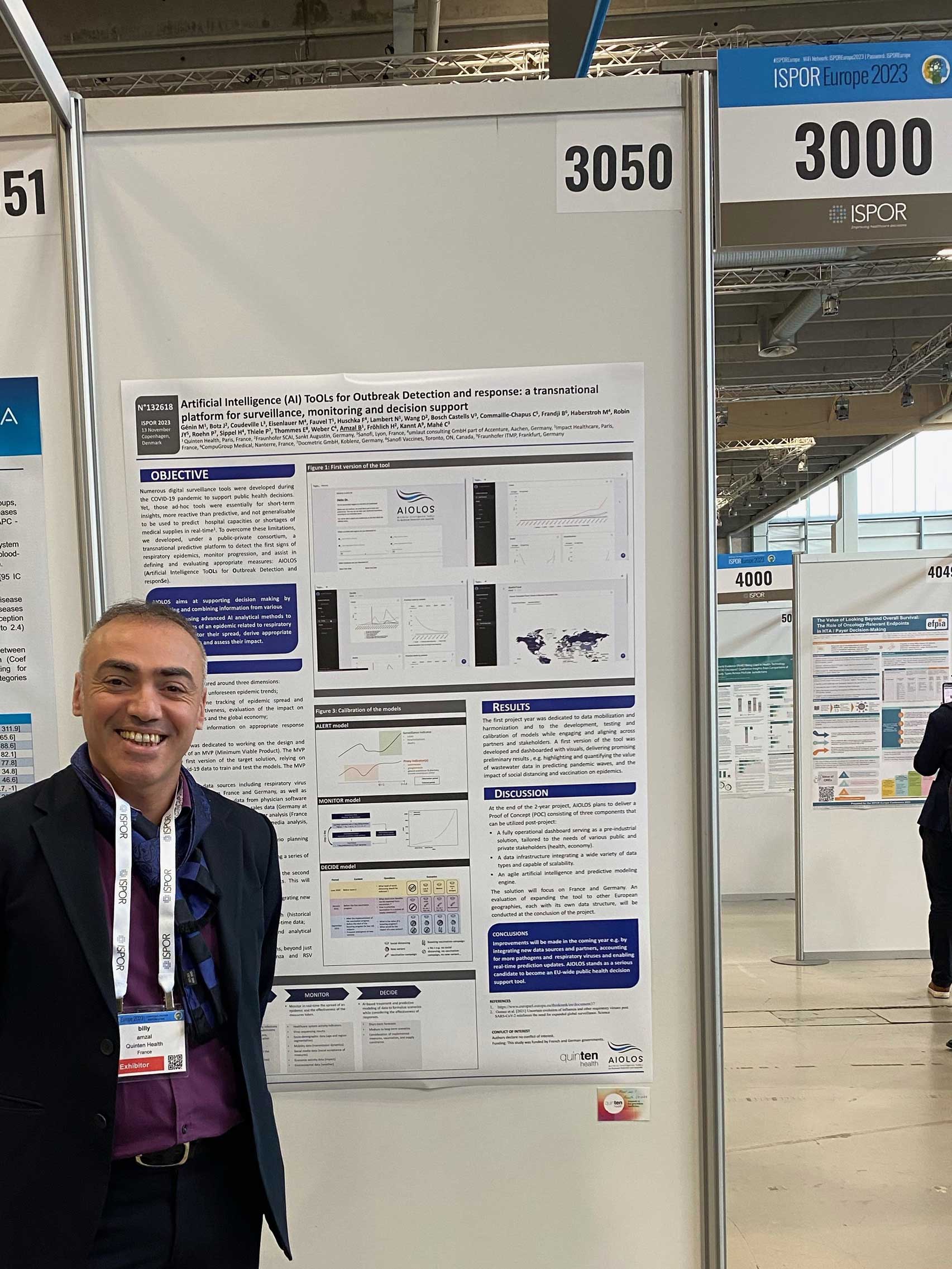 Picture of Billy Amzal (CEO) at ISPOR Europe 2023 in Copenhagen. He is standing in front of the poster AIOLOS 